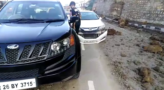 Two vehicles narrowly escaped from being hit by debris in Dharampur.